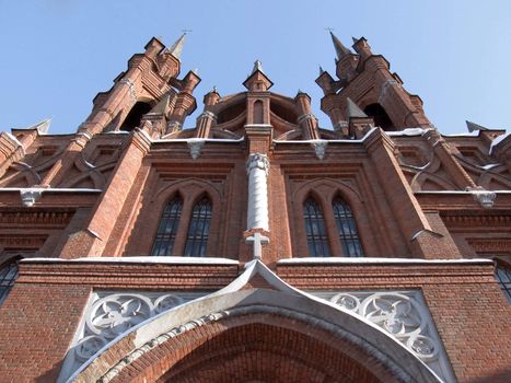 Gothic cathedral with a bell tower against the blue sky.