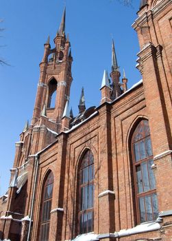 Gothic cathedral with a bell tower against the blue sky.