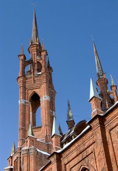 Gothic cathedral with a bell tower against the blue sky.