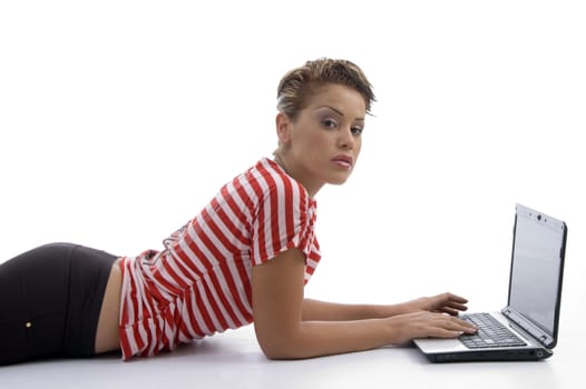 female laying  with laptop on an isolated white background