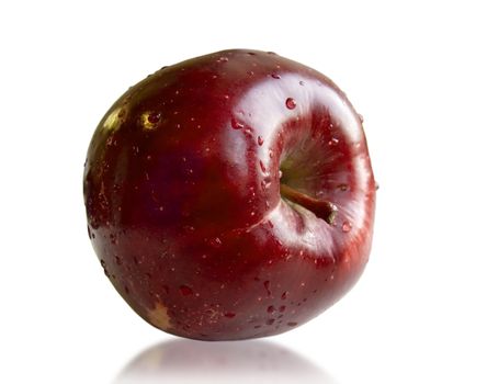 Ripe juicy apple with drops of water on a white background.