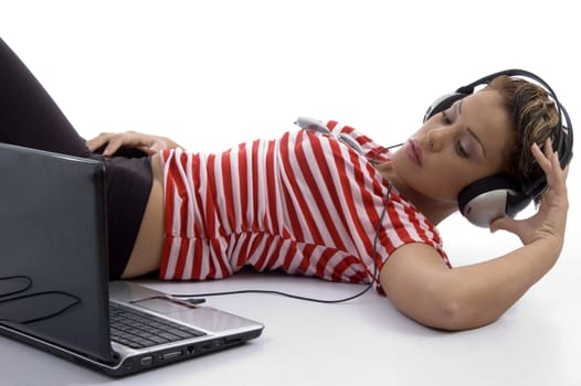 woman holding headphone and looking at laptop on an isolated white background