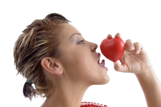 side face of woman licking a heart with white background
