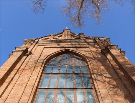 Gothic cathedral with a bell tower against the blue sky.