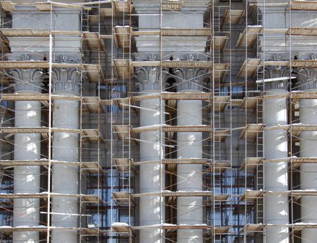 Classical facade with double columns on a warrant repairs. Stalinist architecture.