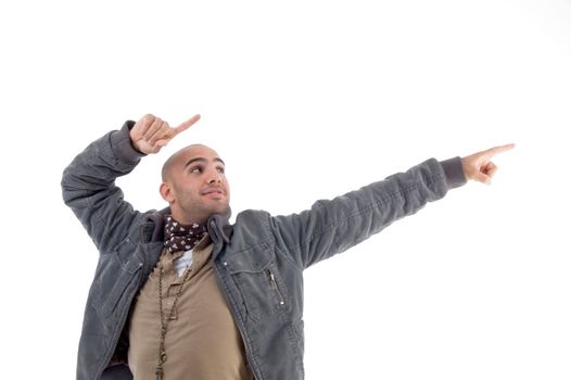 young man pointing sideways against white background