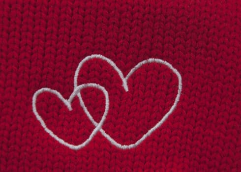 The hearts embroidered with white threads on red background