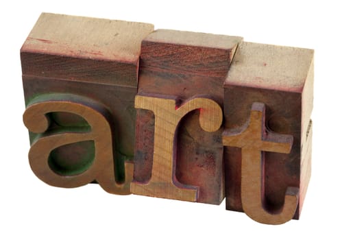 the word of art in vintage wood letterpress type blocks, stained by color ink, isolated on white