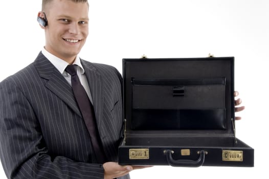 smiling businessman showing his empty office on an isolated white background