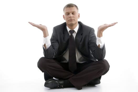 handsome young businessman doing yoga with open palms against white background