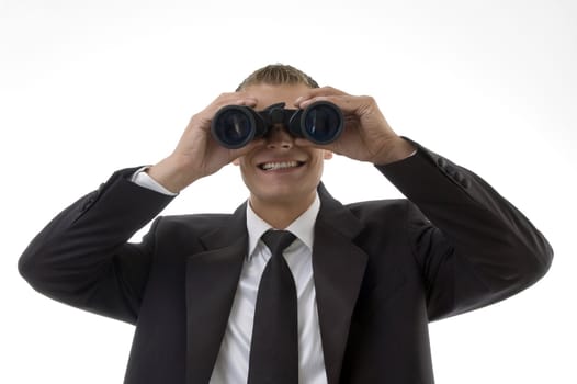 young accountant viewing through binoculars on an isolated white background