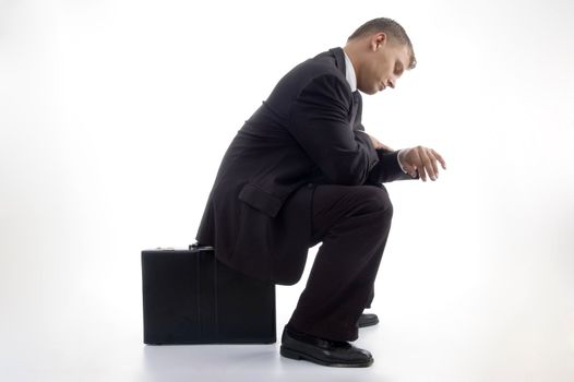 young accountant having a look at his watch on an isolated white background