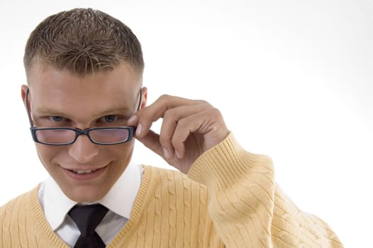young student adjusting his spectacles on an isolated white background