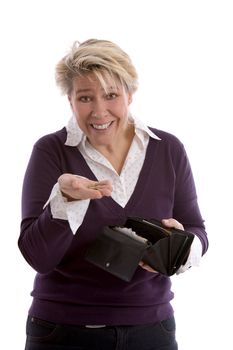 Mature woman holding up a few euro cents with a sheepish expression