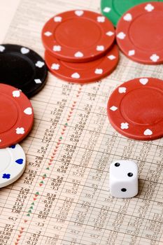 dice and casino chips on a stock market chart