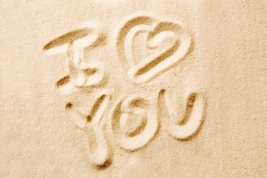 I love you message written in golden sand