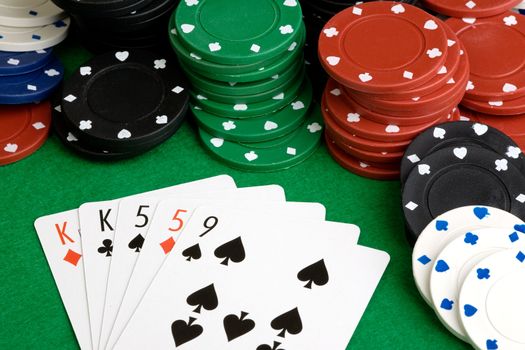 A poker hand with two pair on a green felt table