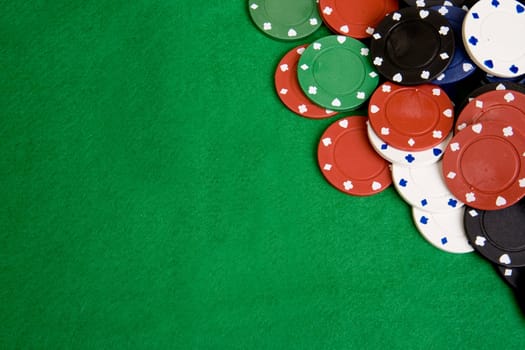 Casino chips on a green felt - background image