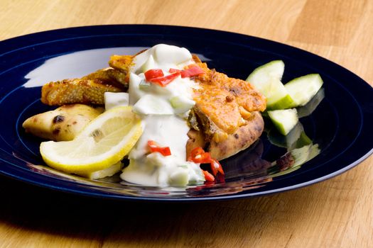 A tantalizing salmon tikki with fresh raita cucmber yogurt