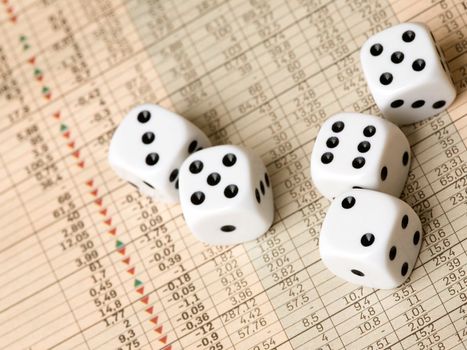 Dice and stock market charts in the newspaper