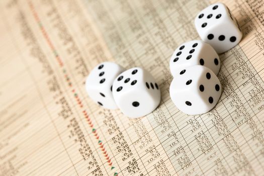 Dice and stock market charts in the newspaper