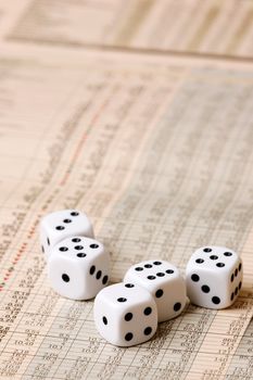 Dice sitting on a stock market chart