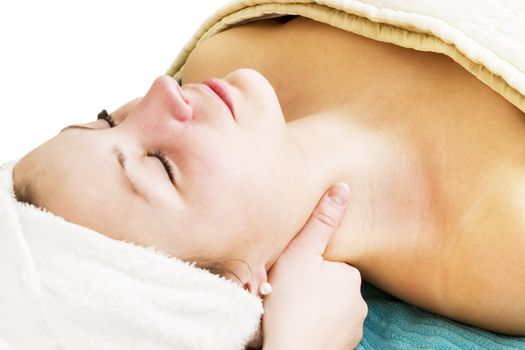 A woman receiving a facial massage at a beauty spa.