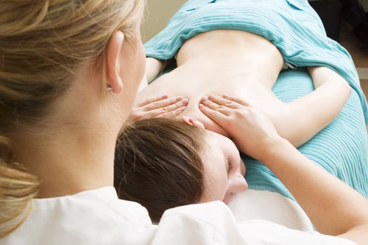 Shoulder massage detail at a beauty spa.