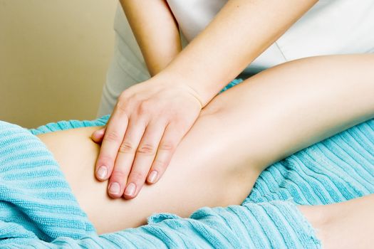 A detail image of a female leg being massaged.