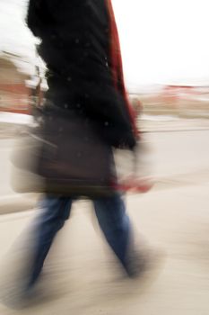 A motion blur abstract of a person walking in a hurry, a late rushing concept image.