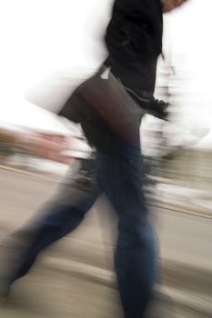 A motion blur abstract of a person walking in a hurry, a late rushing concept image.