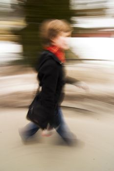 A motion blur abstract of a person walking in a hurry, a late rushing concept image.