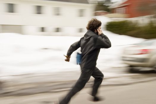 A motion blur abstract of a person walking in a hurry talking on a cell phone