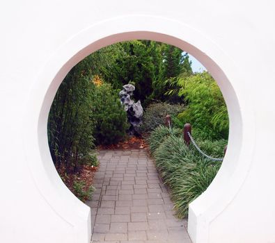 Looking through a circular entrance to a secret garden