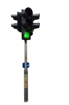 An isolated traffic light from Prague with the green light showing