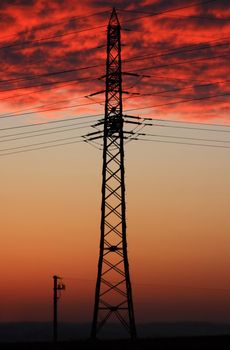 This image shows a big power pole at morning with sunrise