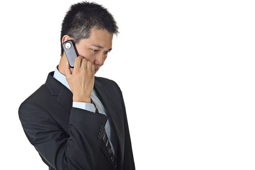 Portrait of a confident young male businessman talking on cellphone with copyspace.