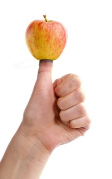 An apple on a thumb, healthy eating concept image.
