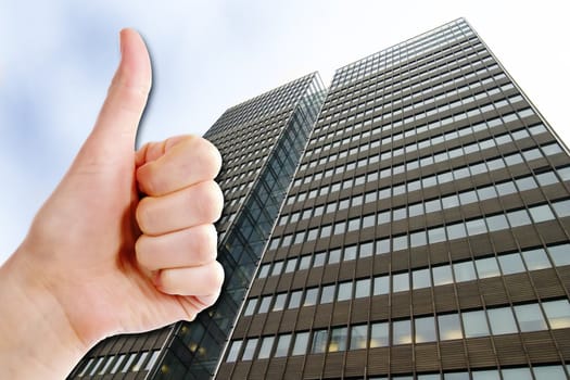 A thumbs up and a tall business building.  Success in Business