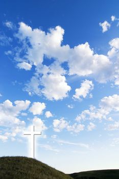 A glowing white cross on a hill.