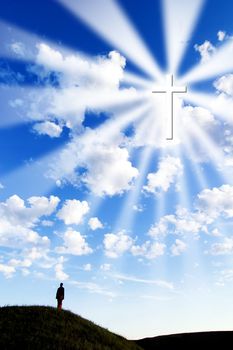 A person on a hill looking up to a glowing cross in the sky.