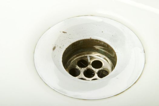 A drain on a retro porcelain sink.