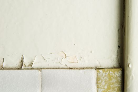 A retro 1970's bathroom wall abstract, with chipped paint and old tiles