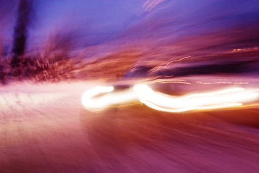 A abstract blur image of a car travelling at night.