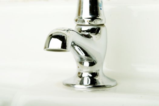 A retro bathroom sink tap detail.