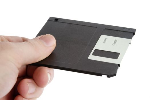 A hand holding a 3 1/2" computer disk.  Isolated on white with clipping path.