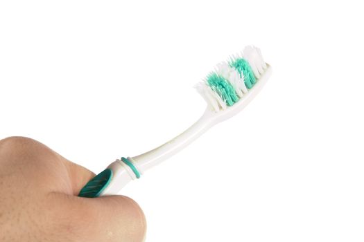 A worn out toothbrush in the hand of a male.