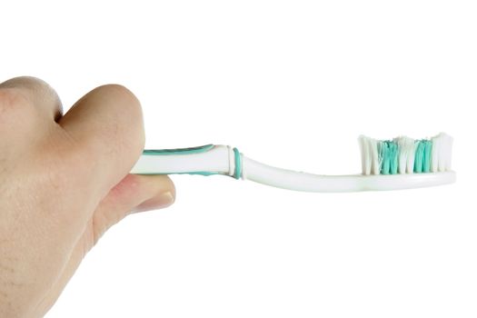 A worn out toothbrush in the hand of a male.