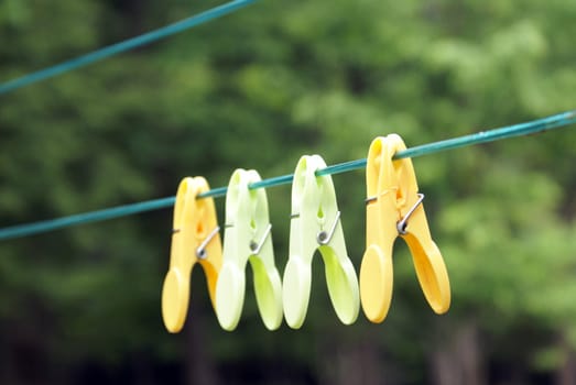 A few clothespins hanging on the line.