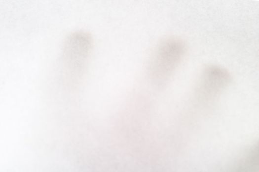 A males hand holding up a white paper with nothing on it, texture background image.  The hand is bairly visible behind the opaque paper.